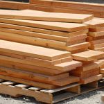 freshly cut wooden boards stacked at lumber mill