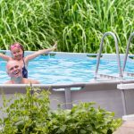 father and daughter excited in backyard pool