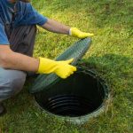 putting lid back on septic tank in backyard