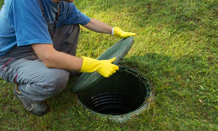 putting lid back on septic tank in backyard